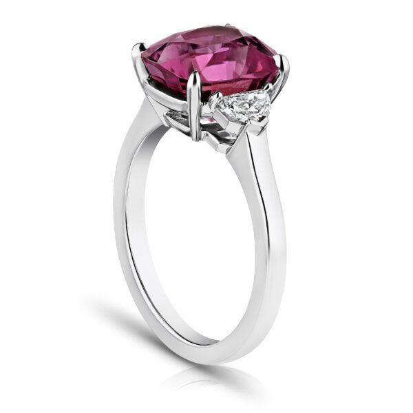 5.88 carat cushion pinkish red sapphire with epaulet cut diamonds .34 carats set in a platinum ring